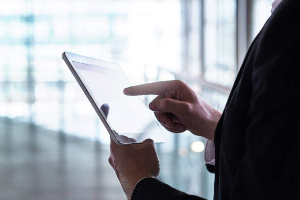 istock Man in a suit using tablet. Businessman with smart mobile device. 938637016
