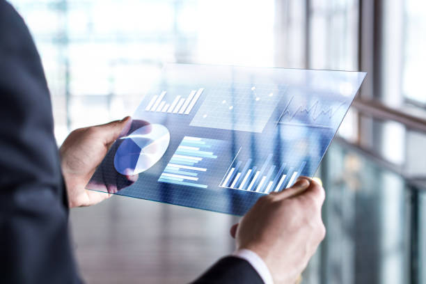 Transparent futuristic tablet. Business man using virtual touch screen. Modern mobile technology in accounting, finance, data and analytics.