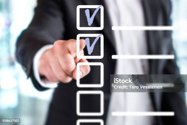 Business Man With Checklist And To Do List Man Writing And Drawing V Sign Check Marks With Hand And Finger In Square Box Stock Photo - Download Image Now