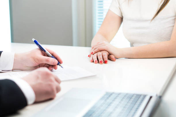 istock Young woman in job interview with business man. Interviewer writing notes. 938640506