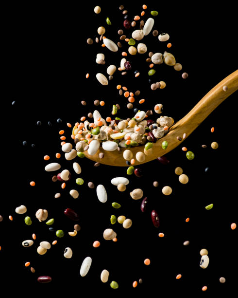 splash of dried vegetable soup - falling beans imagens e fotografias de stock