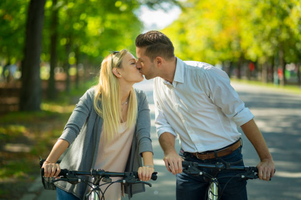 istock couple kissing on bikes 938647590