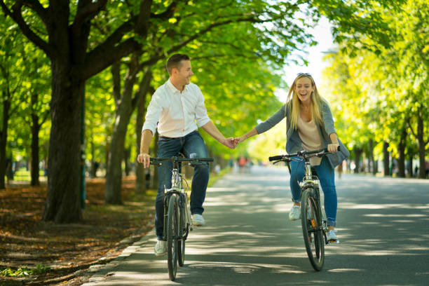 istock happy couple having fun on bikes 938647716