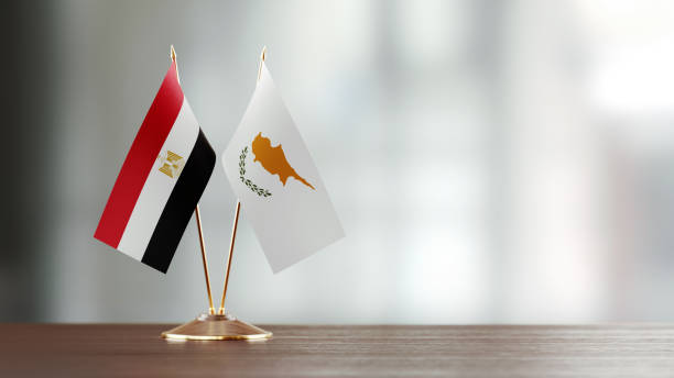 istock Egyptian And Cypriot Flag Pair On A Desk Over Defocused Background 938648576