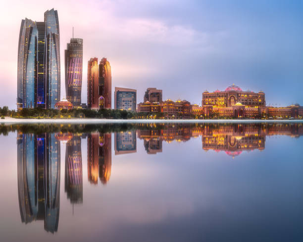 View of Abu Dhabi Skyline at sunrise, UAE View of Abu Dhabi Skyline at sunrise with cloudy sky, United Arab Emirates corniche photos stock pictures, royalty-free photos & images