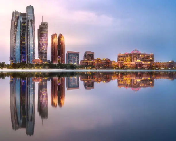 View of Abu Dhabi Skyline at sunrise with cloudy sky, United Arab Emirates