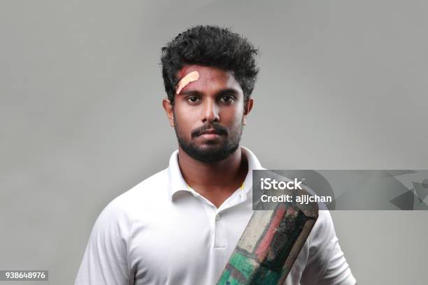 Young Man With A Bruised Forehead Holds A Cricket Bat Stock Photo -  Download Image Now - iStock