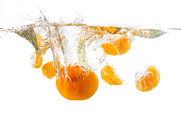istock Fresh mandarin falling in water splash, isolated on white. 938649232