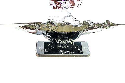 Smartphone in the water and splash on a white background. Waterproof mobile phone.