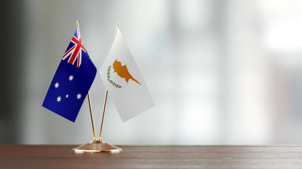istock Australian And Cypriot Flag Pair On A Desk Over Defocused Background 938656352