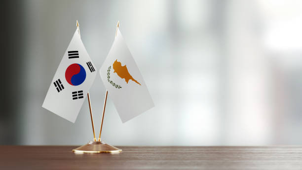 istock South Korean And Cypriot Flag Pair On A Desk Over Defocused Background 938656836