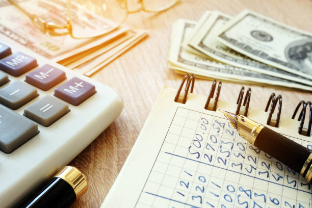 istock Money, calculator, pen and accounting book on a desk. 938657052