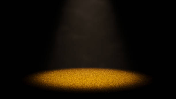 istock twinkling golden glitter on a stage lit by a round spotlight through dusty air 938657596