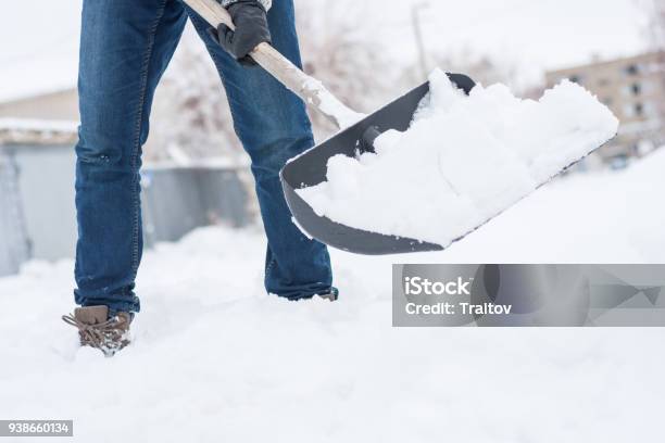 Lose Up View Of Snow Shovel Wih Snow In Mans Hands Man Clean Backyard Of His Hause After Blizzard Stock Photo - Download Image Now