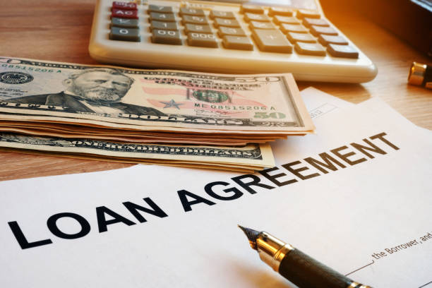 istock Loan agreement, money and calculator on a desk. 938660342