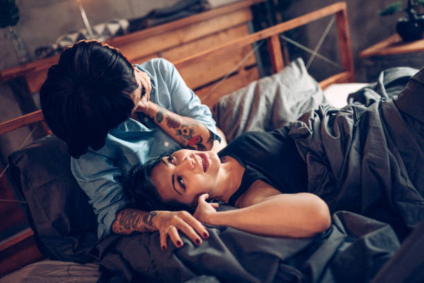 istock Lesbian couple laying on bed and using laptop 938660954
