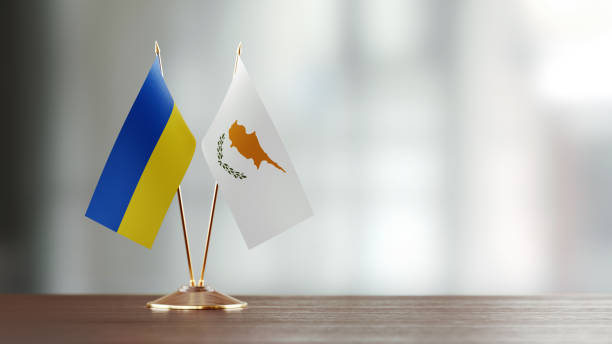 istock Ukrainian And Cypriot Flag Pair On A Desk Over Defocused Background 938661296