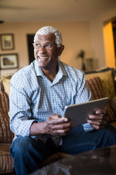 istock Senior Black Businessman Working From Home on Tablet 938666642