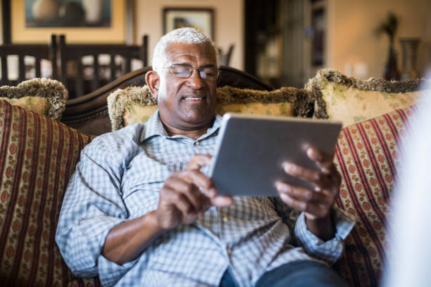 istock Senior Black Businessman Working From Home on Tablet 938666724