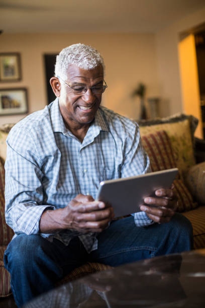 istock Senior Black Businessman Working From Home on Tablet 938666726