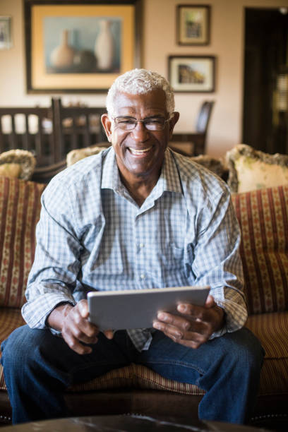 istock Senior Black Businessman Working From Home on Tablet 938666774