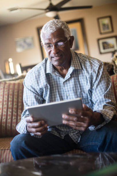 istock Senior Black Businessman Working From Home on Tablet 938666782
