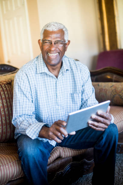 istock Senior Black Businessman Working From Home on Tablet 938666844