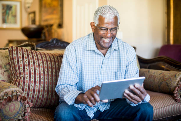 istock Senior Black Businessman Working From Home on Tablet 938666978