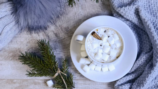 istock Coffee with marshmallows at the Christmas tree. Festive warming 938673376