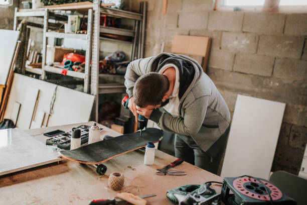 istock Teenage boy adjusting screws on skateboar 938676988