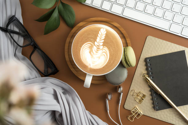 istock Styled stock photography brown office desk table with blank notebook, computer, supplies and coffee cup. Top view with copy space. Flat lay. 938677774
