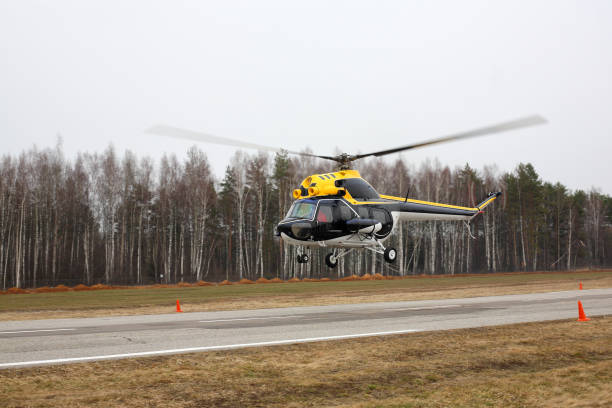 istock Aircraft - Black-yellow helicopter makes flight at low height side view 938678082