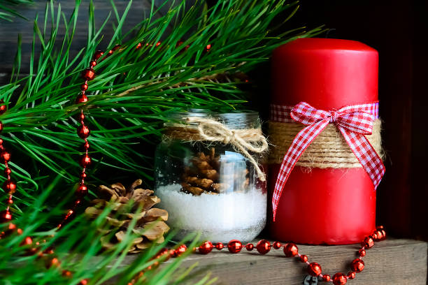 istock Candle on the table near the Christmas tree. Christmas present 938680362
