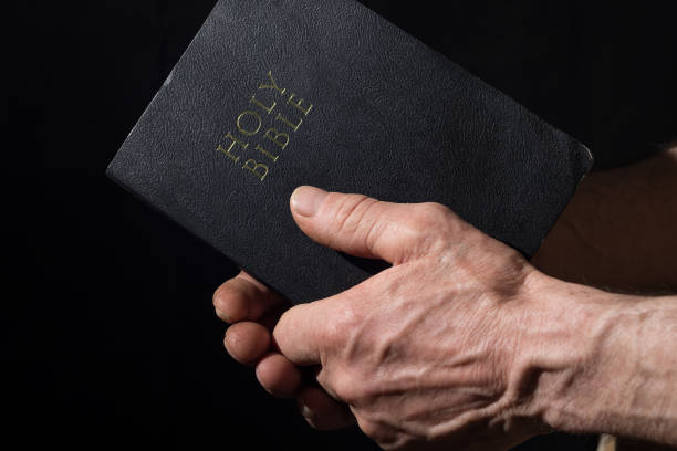 istock Aged man's hands holding the Bible 938683588