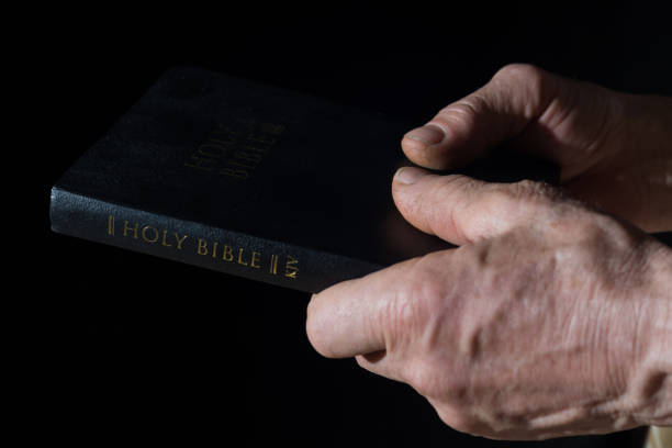 istock Aged man's hands holding the Bible 938683610