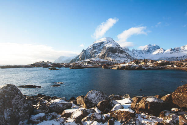 Beautiful super wide-angle winter snowy view of fishing village A, Norway, Lofoten Islands, with skyline, mountains, famous fishing village with red fishing cabins, Moskenesoya, Nordland Beautiful super wide-angle winter snowy view of fishing village A, Norway, Lofoten Islands, with skyline, mountains, famous fishing village with red fishing cabins, Moskenesoya, Nordland"n harbor of svolvaer in winter lofoten islands norway stock pictures, royalty-free photos & images