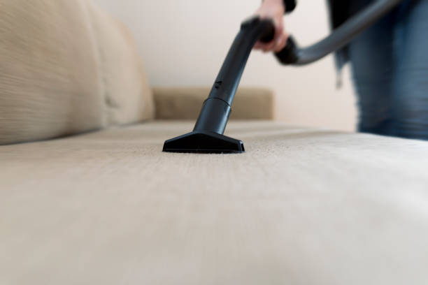 Blue, compact vacuum cleaner ready for work. Isolated on white.