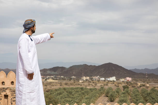 arab man in traditional omani outfit in an old castle stock photo