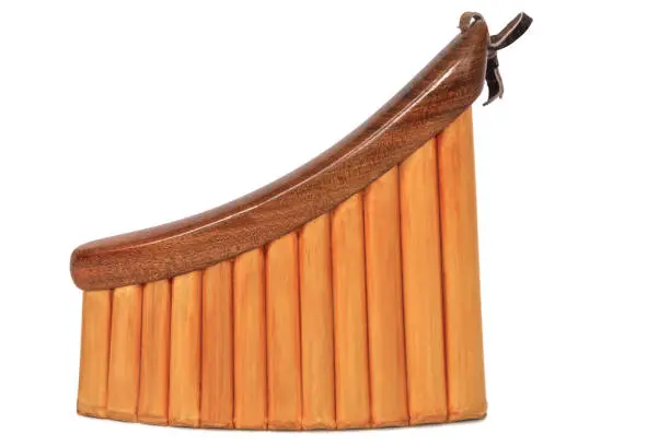 Photo of Pan flute, isolated on white. Panpipe, isolated on white color. Traditional musical instrument - pan flute. Pan flute isolated on white background.