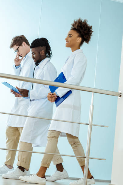 istock medical interns walking in hospital 938698878