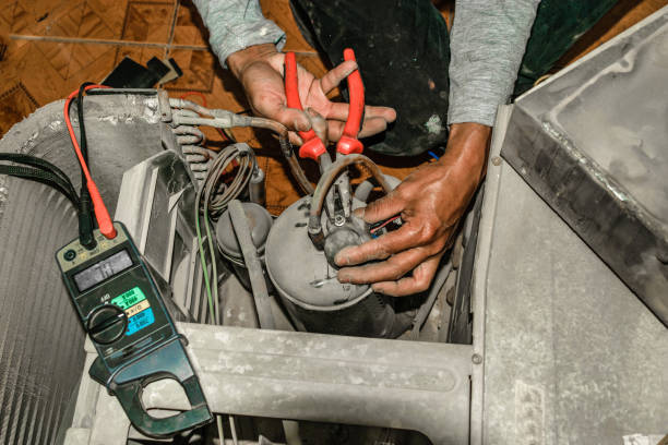 istock a professional ac technician is refiling the Freon into the compressor of a window air conditioner unite and the gas pressure is illuminated on the meter 938699134
