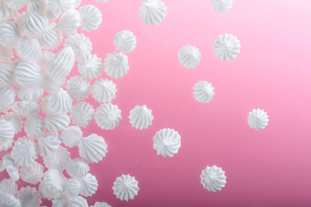 istock French vanilla meringue cookies on pink background with copy space. 938702582