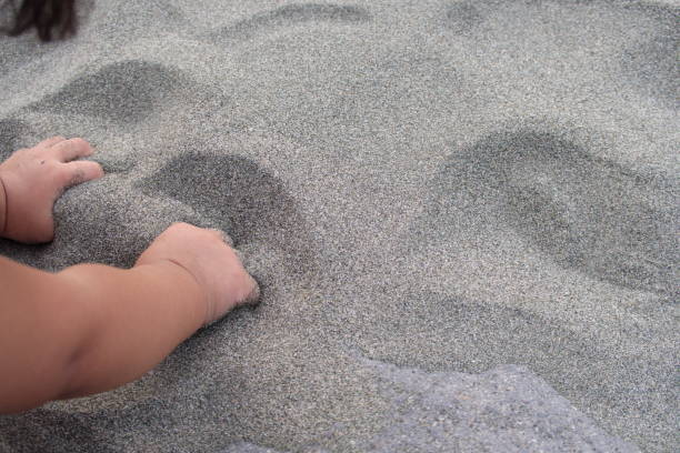 Portrait of  boy burried in sand