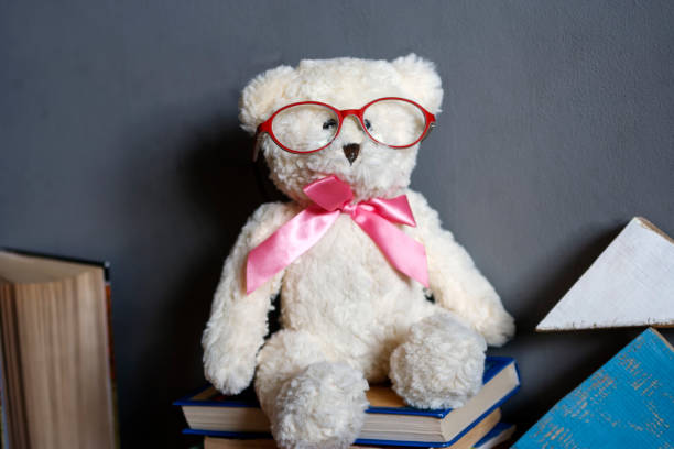 istock Clever white teddy bear in red glasses 938708356
