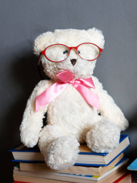 istock Clever white teddy bear in red glasses 938708390