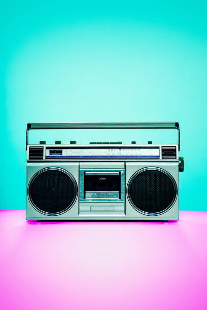 Vintage Boombox Personal Stereo An image of a personal tape player stereo sound system from the late 1980s - early 1990's, a pink and color background reflecting the colors of that era. boom box stock pictures, royalty-free photos & images