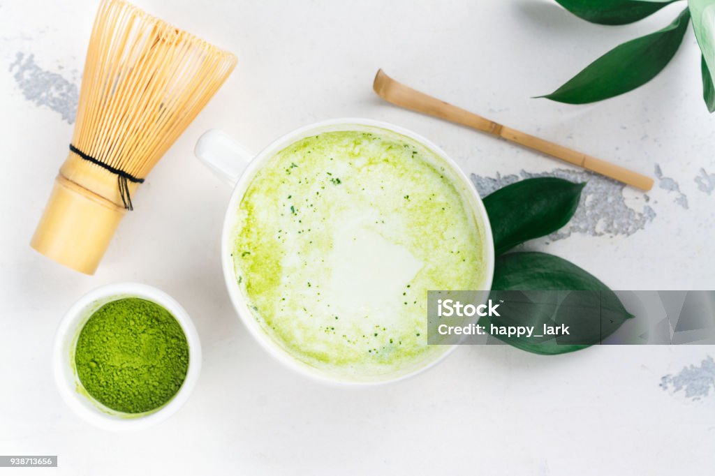 Matcha green tea latte in a cup Matcha green tea latte in a cup and tea ceremony utensils. Copy space Matcha Tea Stock Photo