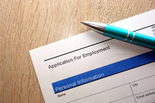 istock Employment application form and pen on desk 938716144