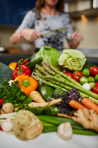 istock Woman sharpening knife to cut veggies 938717266
