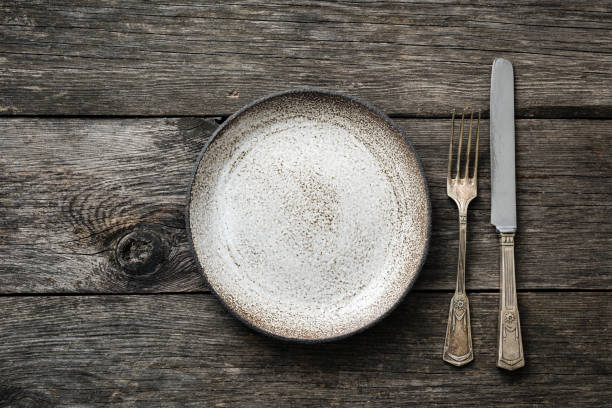 istock Table setting with vintage silverware or cutlery and empty plate on rustic wood 938718306